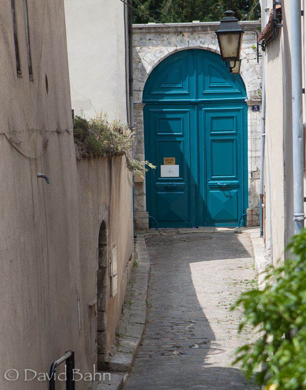 Teal Doors at the End of an Alleyway