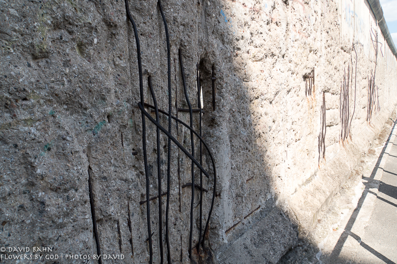 The rebar shows in the concrete of the Berlin Wall